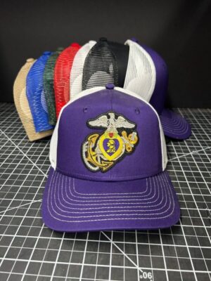Purple cap with embroidered military emblem.