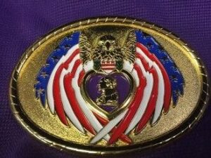 Gold belt buckle with eagle and flags.
