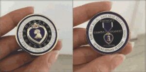 Person holding a commemorative military coin.