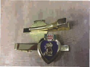 Gold tie clips with military insignia designs.