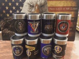 Military-themed tumblers with patriotic background.