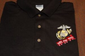 Black polo shirt with Toys for Tots logo.