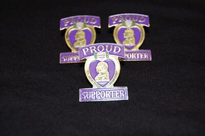 Three purple heart proud supporter pins.