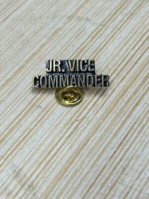 JR. Vice Commander badge on wood surface.