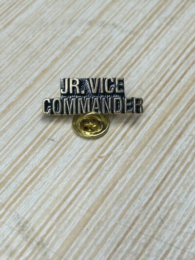 JR. Vice Commander badge on wood surface.
