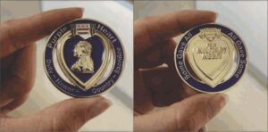 Military medal with heart-shaped design, inscription.