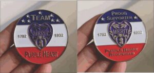Purple Heart commemorative coins in hand.