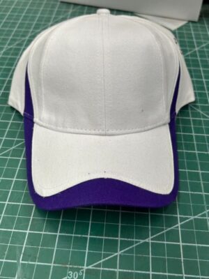 White and purple cap on cutting mat.