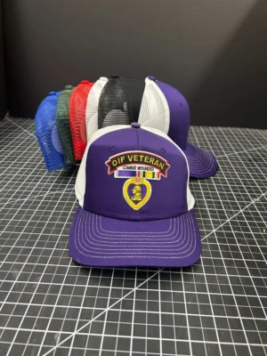 Purple "OIF Veteran" cap on display.