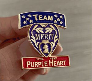 Team Merit Purple Heart commemorative pin badge.