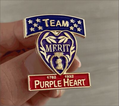 Team Merit Purple Heart commemorative pin badge.