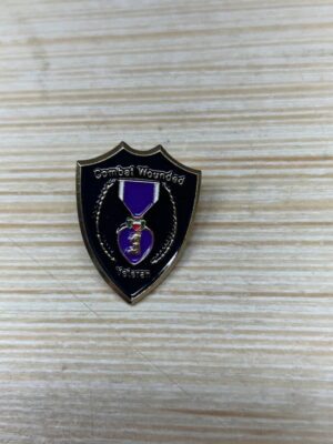 Combat Wounded Veteran badge on wood surface.