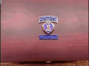 Purple Heart medal on wooden display case.
