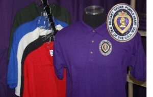 Purple Heart shirts on display with logo.