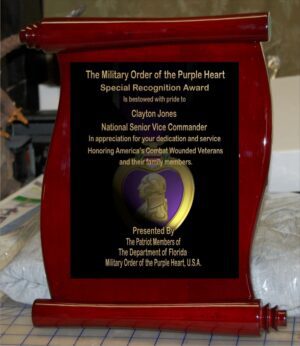 Red scroll-shaped military recognition award.