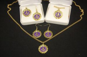 Gold and purple jewelry set on display.