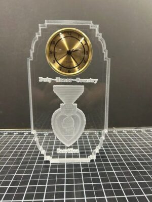 Transparent clock with engraved military design.