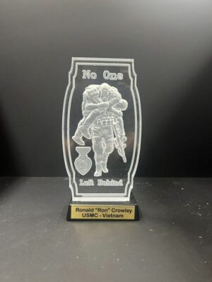Military plaque with engraved soldier and medal.