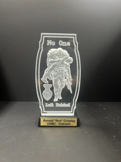 Military plaque with engraved soldier and medal.