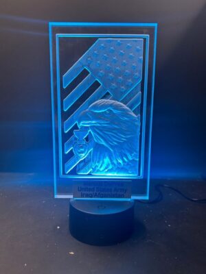 Illuminated plaque with eagle and flag design.