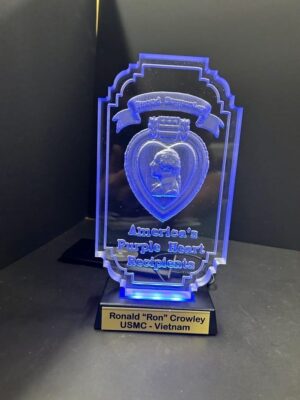 Blue Purple Heart award on display stand.