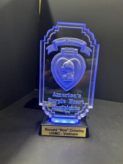 Blue Purple Heart award on display stand.