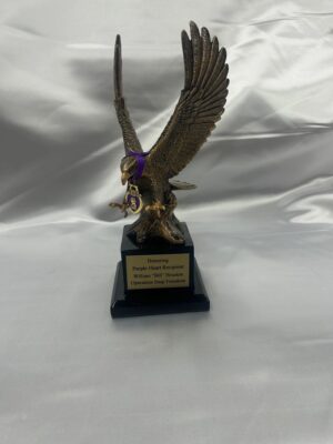 Eagle trophy with a purple ribbon.